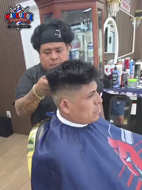 Marcos finishing a haircut at Marquitos Barbershop